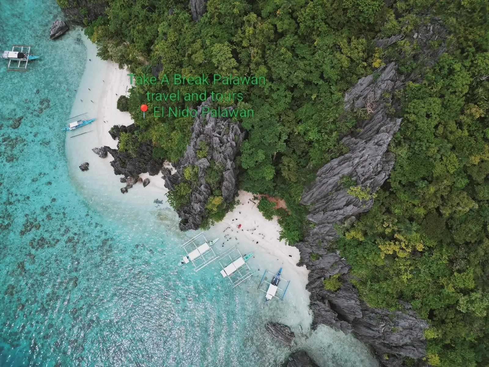 A white-sand cove and turquoise shallows from the air