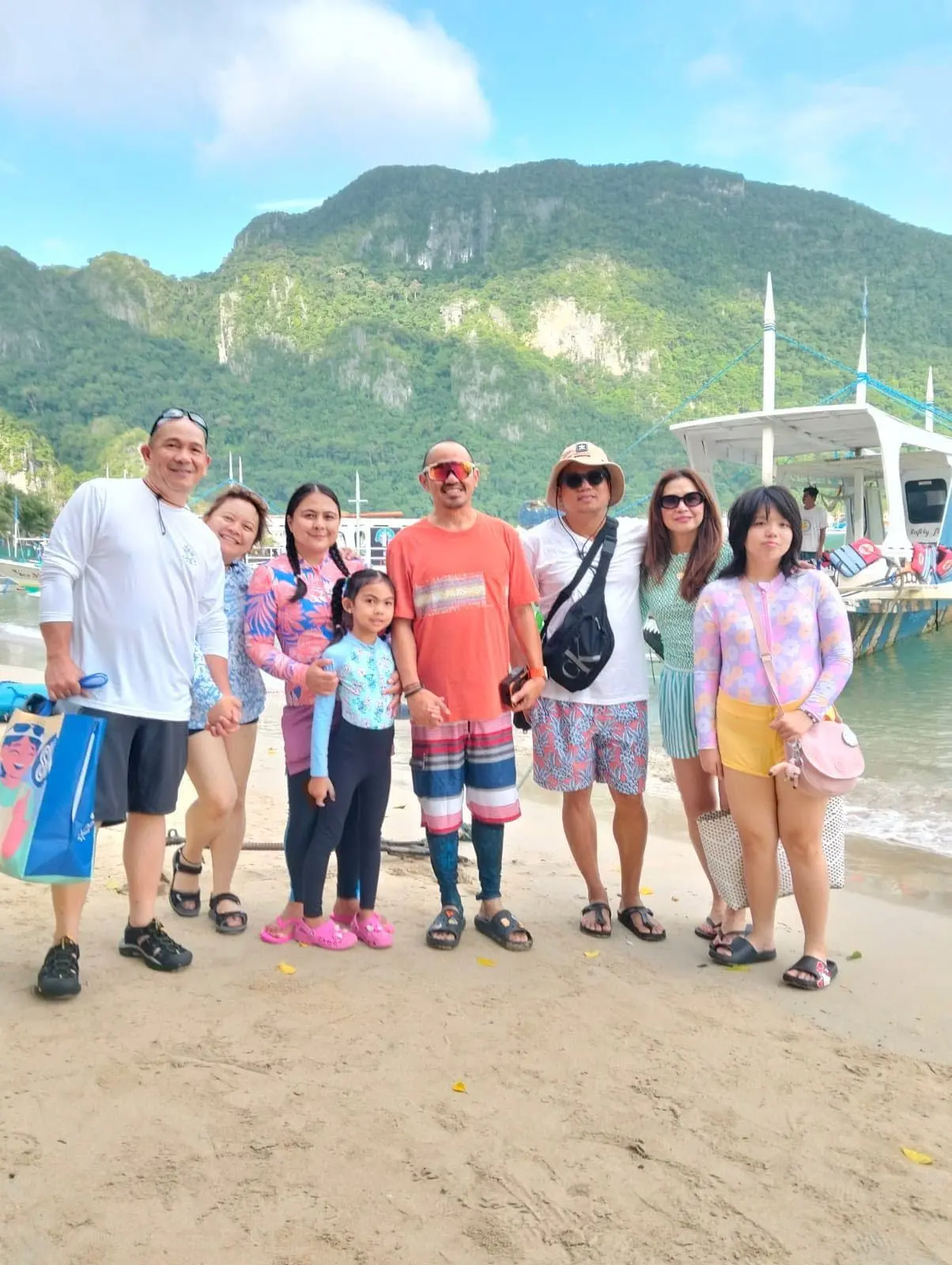 A family group on the sand beside their tour boat