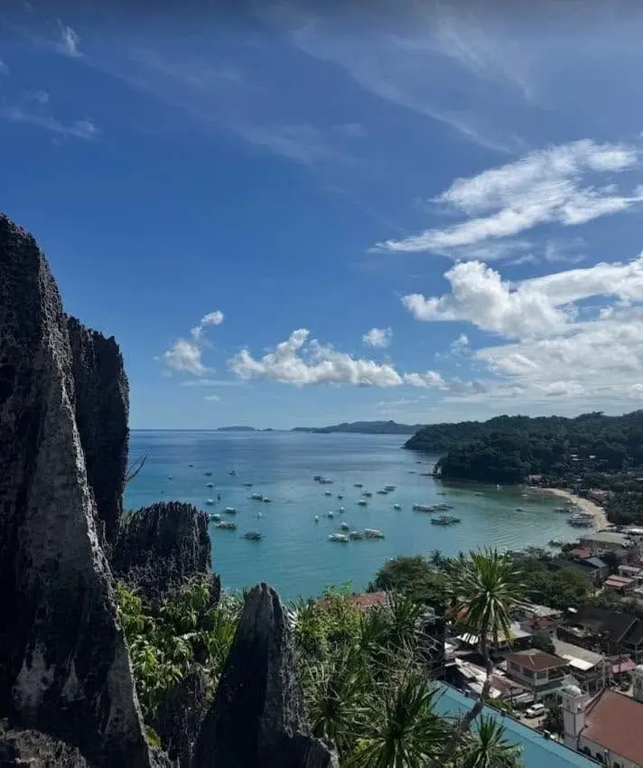 The bay and town of El Nido seen between limestone peaks