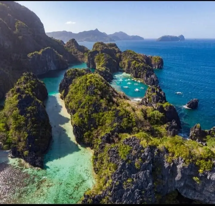 Limestone islands and coves in the blue sea off El Nido